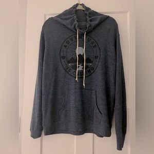 Blue sweatshirt, cowl neck. Brand is well worn.